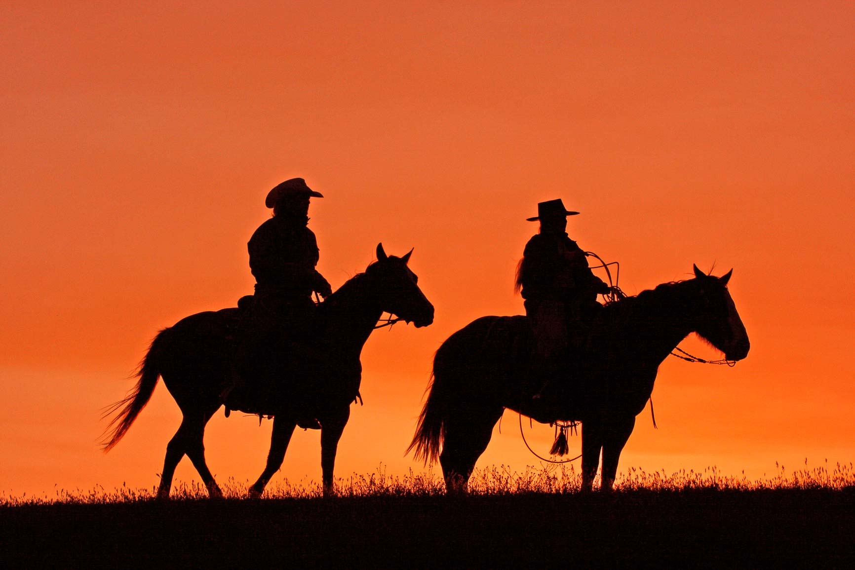 Silhouettes of cowboys on horseback at sunset, Source: Photodune.net