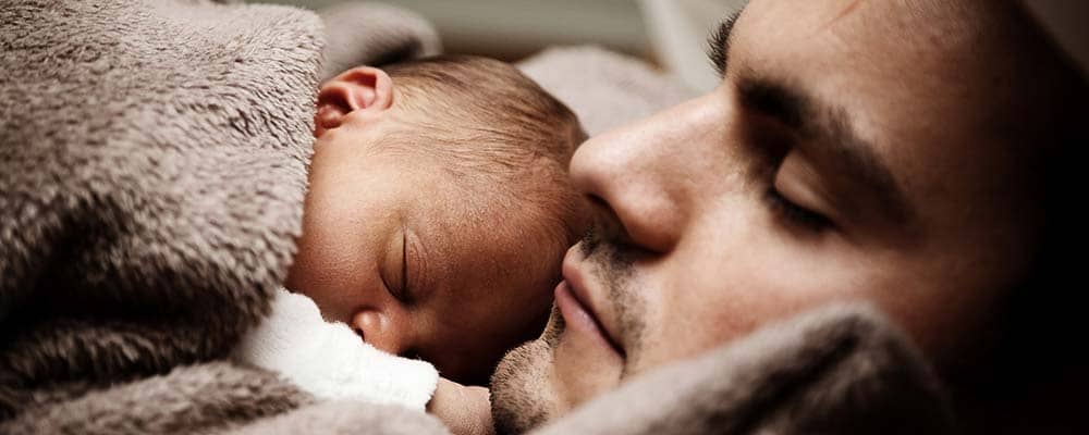 Newborn baby and father sleeping, Source: Pexels