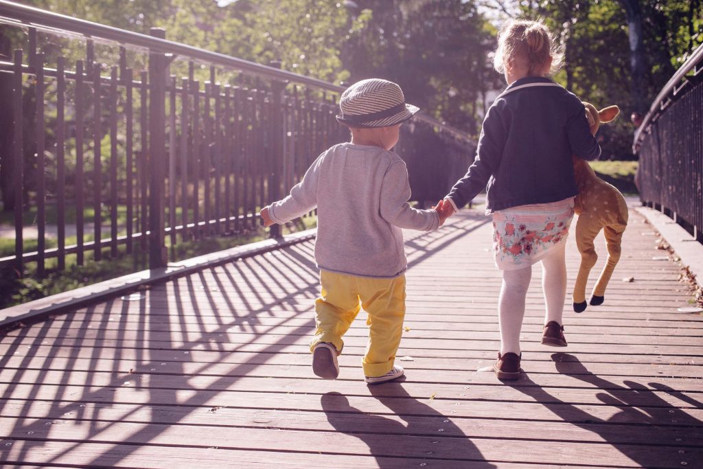 Toddler boy and his sister on a bridge, Source: Stocksnap.io getting great photos of your toddler