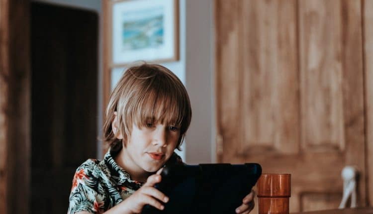 A young boy playing with a tablet device, Source: Kyle Ford, HDDMag.com unhealthy gaming habits