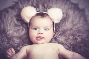 Baby in a headband with puffy balls on top, Source: Clara Morton, Sleeping Angels Co newborn care specialist